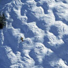 Karl Weatherly/Corbis: Skier on a mogul run: Brett Dueter skis moguls in Sun Valley, Idaho (detail)